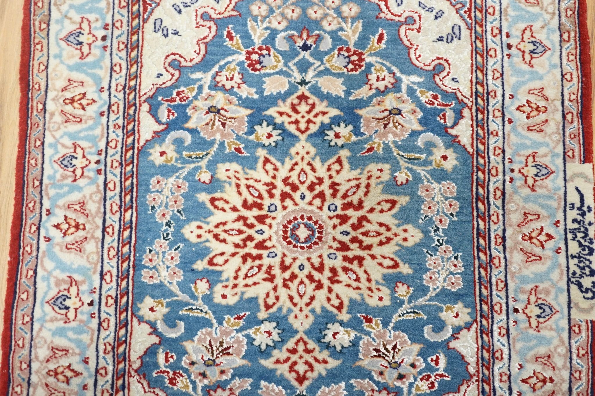 A north-west Persian blue-ground floor mat, signed, 42x53cm